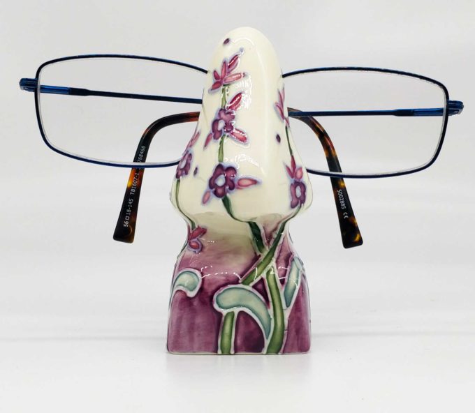 Glasses Stand made from ceramics and tubelined with purple flower pattern - nose shaped