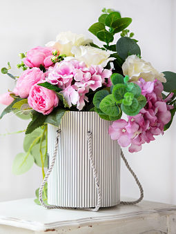 pink roses and white flowers display in container